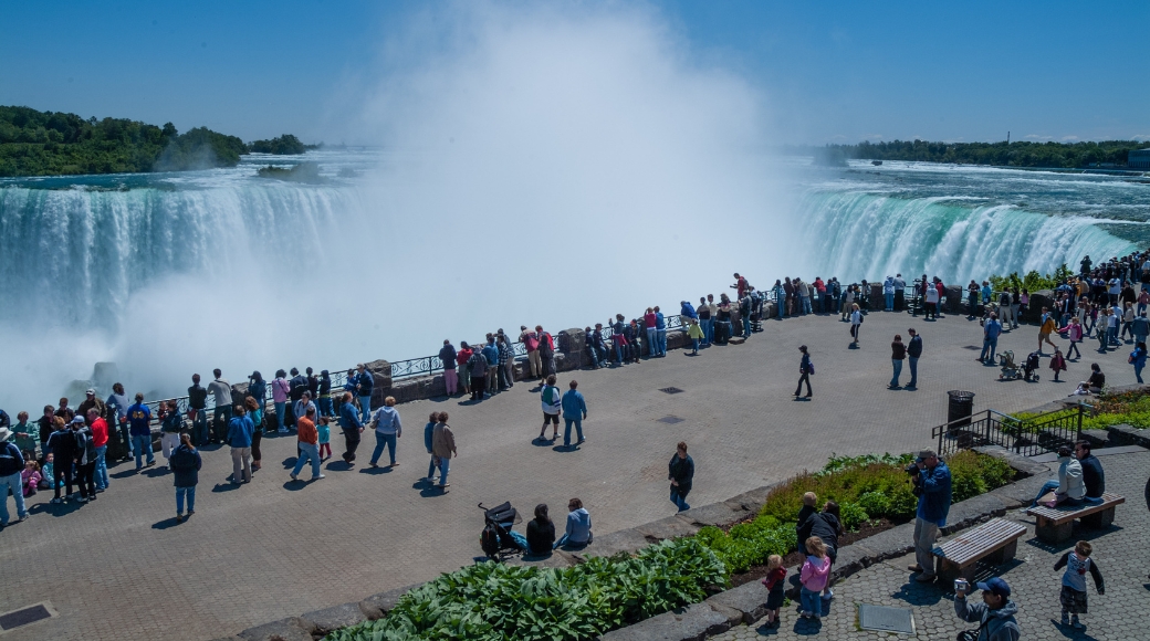 A crowded balcony with numerous visitors enjoying a breathtaking view of Niagara Falls.